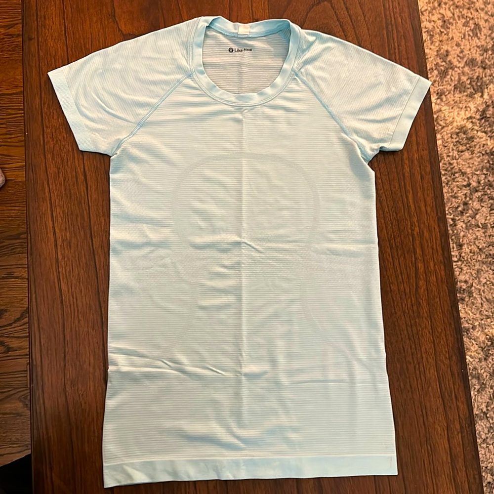 Lululemon “Like New” swiftly tech short sleeve, light blue, size 6.